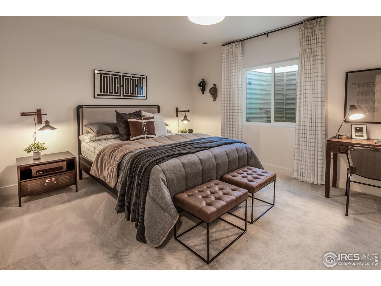792 Chatter Road Windsor, CO 80550 - Photo 36 of 42 a spacious bedroom with a bed a table and chair