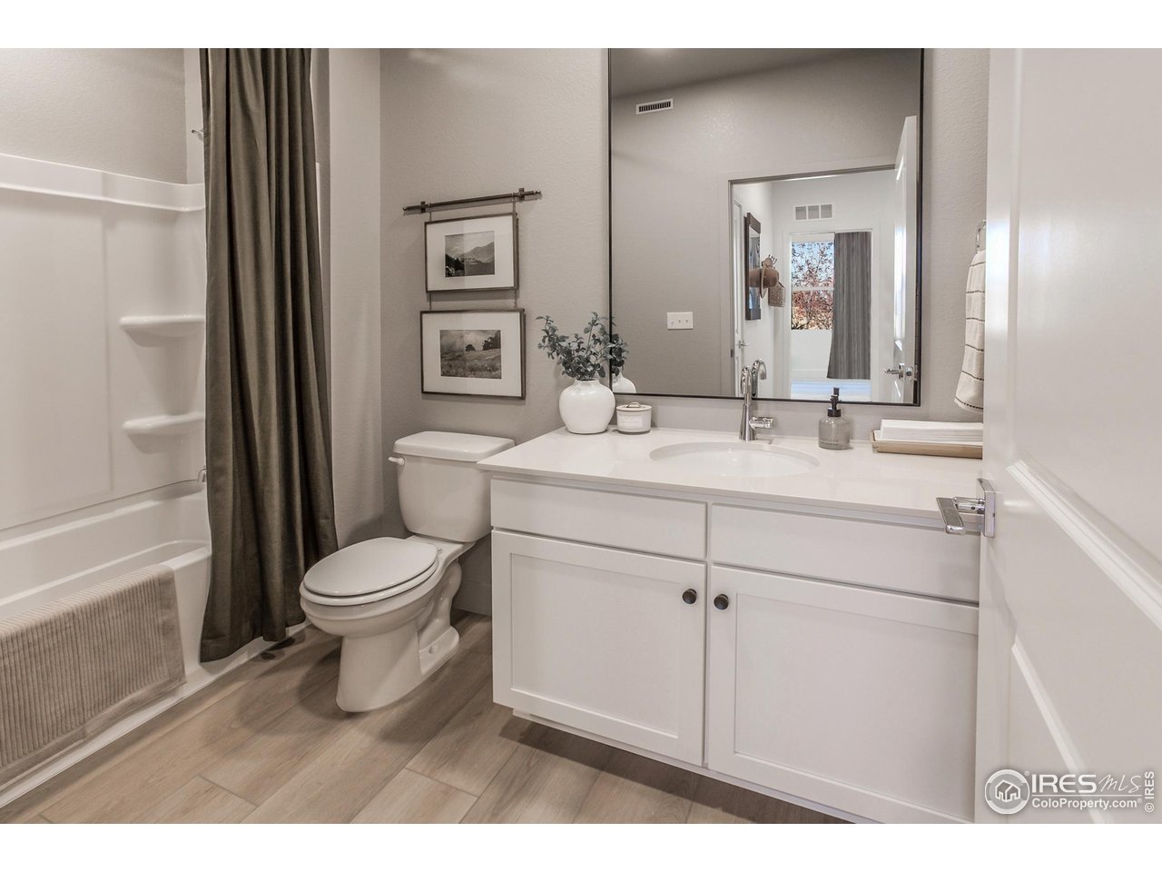 792 Chatter Road Windsor, CO 80550 - Photo 5 of 42 a bathroom with a toilet sink and mirror