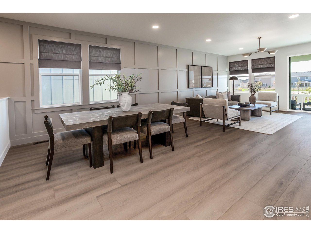 792 Chatter Road Windsor, CO 80550 - Photo 7 of 42 a view of a dining room with furniture and wooden floor
