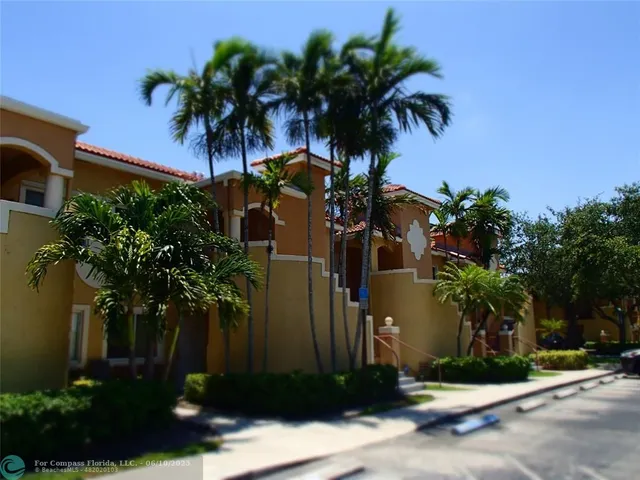 a couple of palm trees in front of house