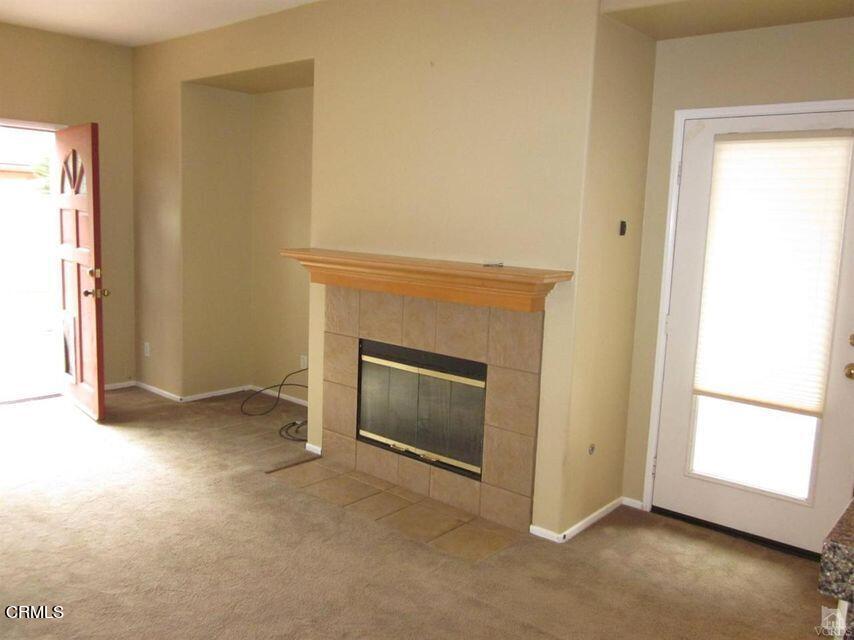 1731 Sonata Drive Oxnard, CA 93030 - Photo 7 of 13 an empty room with a fireplace