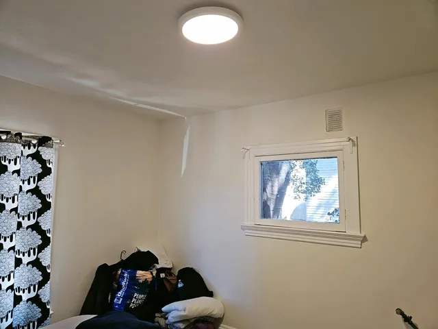 a bedroom with a bed and a window