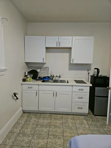 a kitchen with a sink stove and cabinets