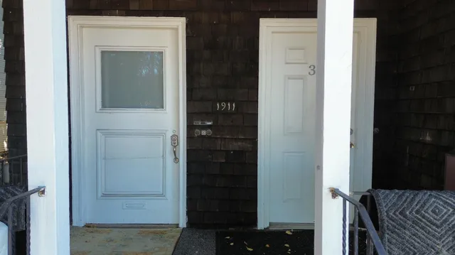 a view of staircase with white walls and a window