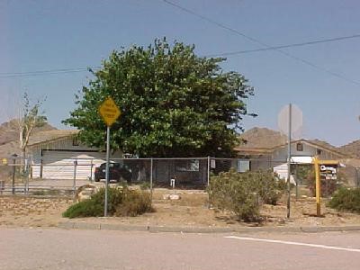 16761 Huasna Road Apple Valley, CA 92307 - Photo 1 of 1 a backyard of a house with lots of green space