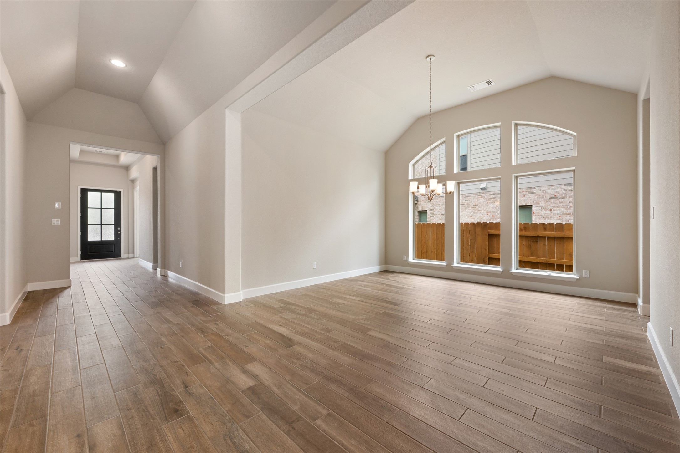 104 Anejo Bluff Georgetown, TX 78628 - Photo 17 of 40 a view of an empty room with wooden floor and a window