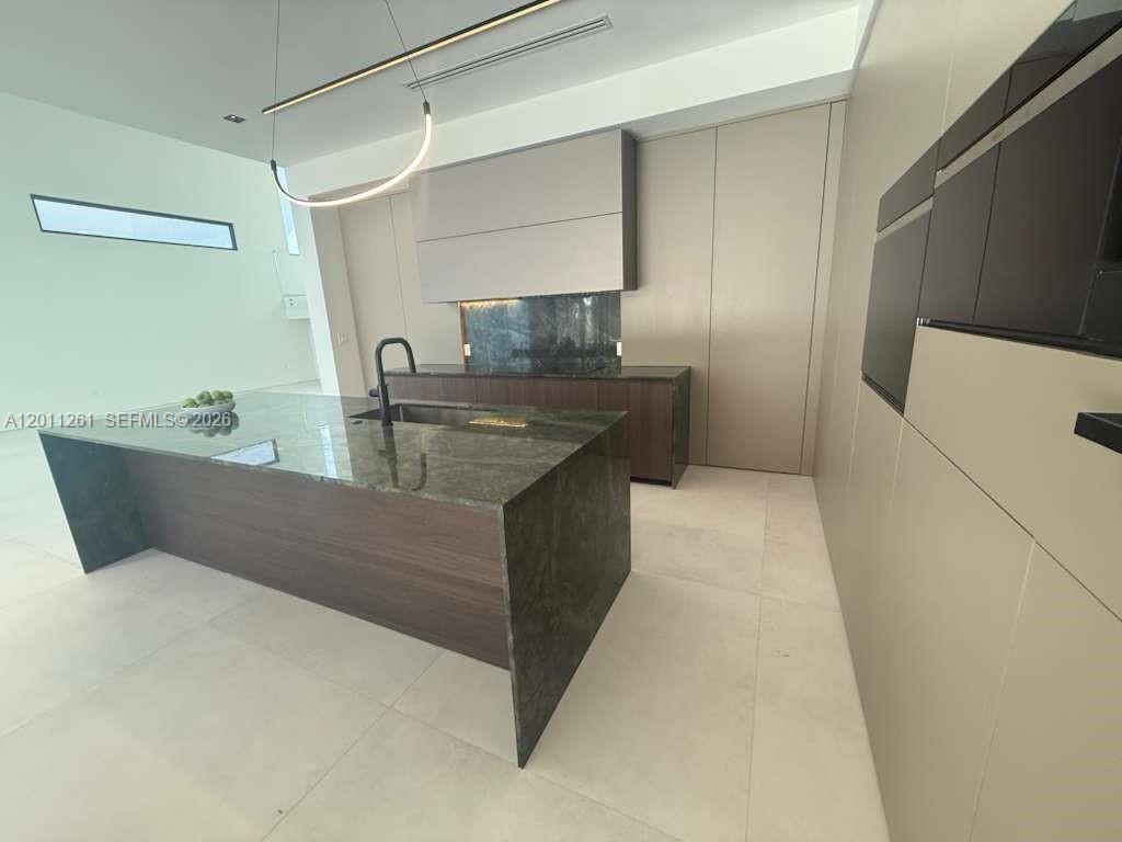 135 Southwest 29th Road Miami, FL 33129 - Photo 12 of 47 a kitchen with stainless steel appliances granite countertop a sink and a refrigerator