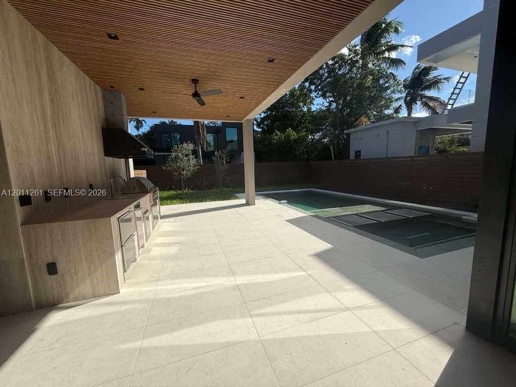 135 Southwest 29th Road Miami, FL 33129 - Photo 19 of 47 a patio with table and chairs and potted plants