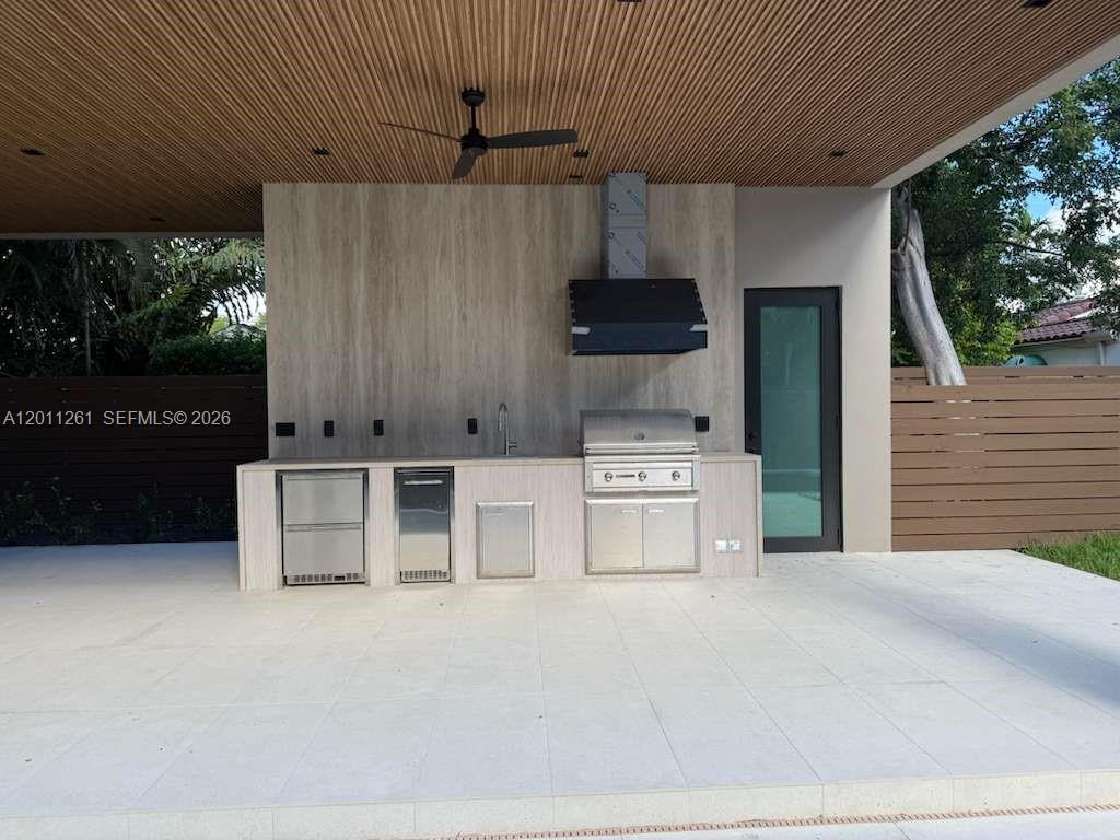 135 Southwest 29th Road Miami, FL 33129 - Photo 20 of 47 a kitchen with stainless steel appliances kitchen island granite countertop a stove a sink and a microwave