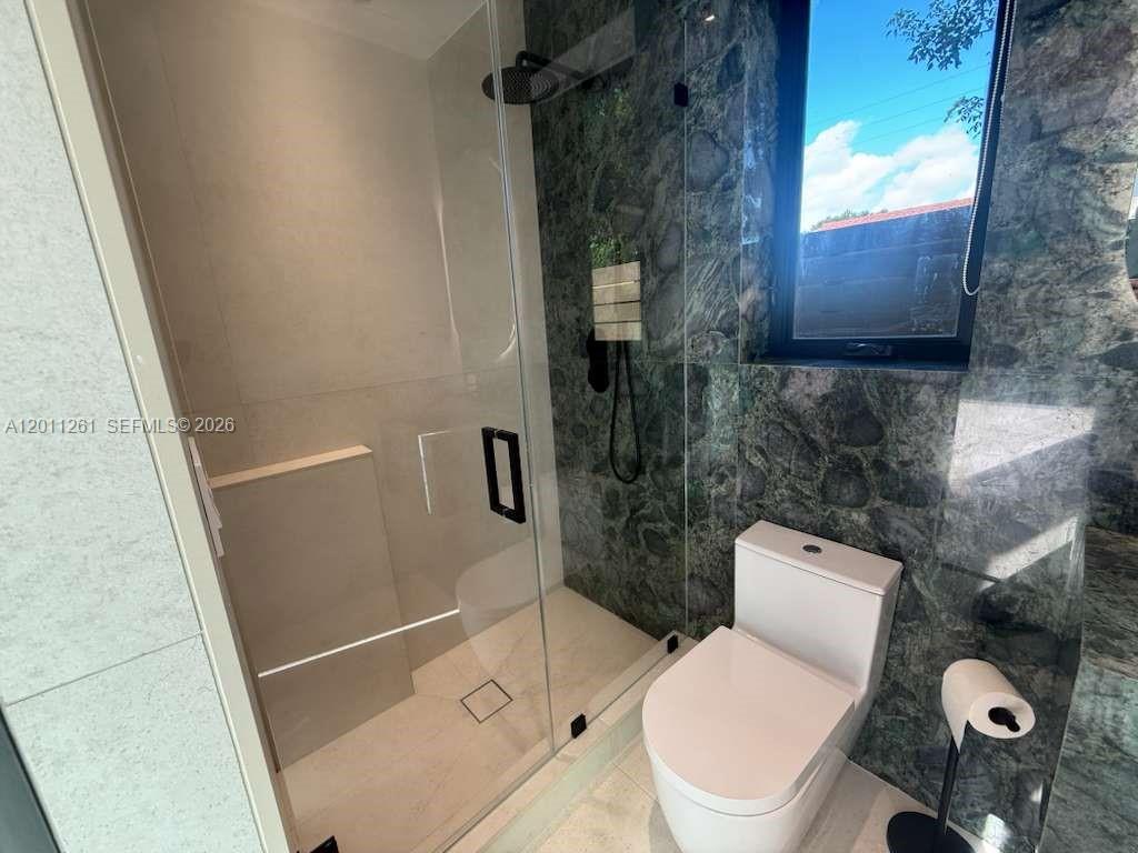 135 Southwest 29th Road Miami, FL 33129 - Photo 26 of 47 a white toilet sitting next to a shower