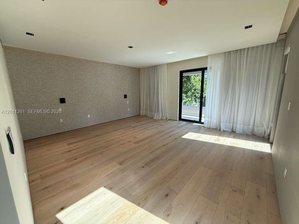 135 Southwest 29th Road Miami, FL 33129 - Photo 27 of 47 a view of an empty room with wooden floor and a window