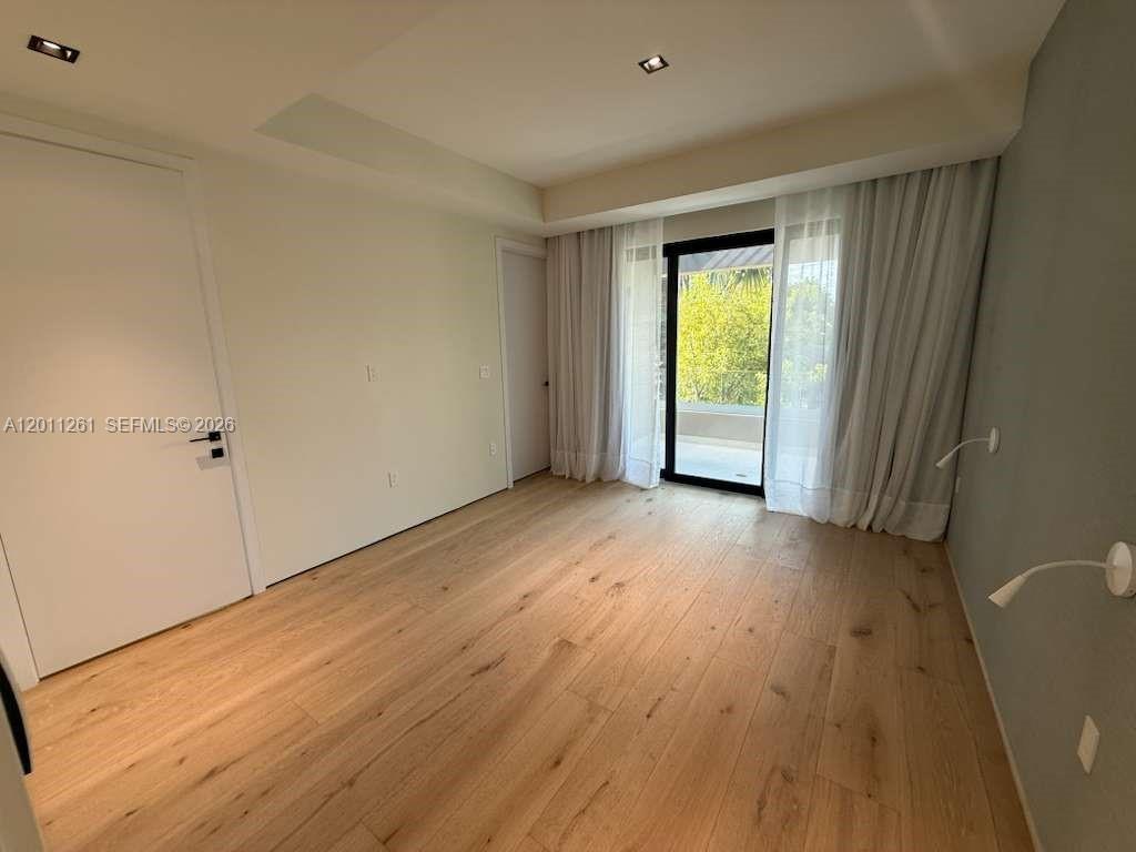 135 Southwest 29th Road Miami, FL 33129 - Photo 37 of 47 a view of an empty room with wooden floor and a window