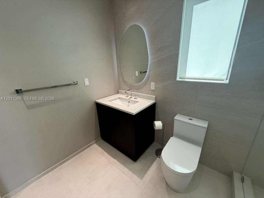 135 Southwest 29th Road Miami, FL 33129 - Photo 38 of 47 a bathroom with a toilet sink and mirror