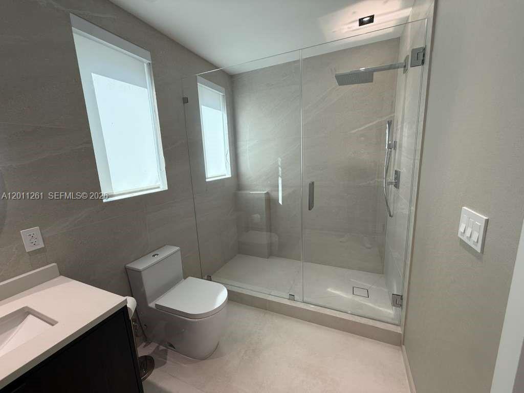 135 Southwest 29th Road Miami, FL 33129 - Photo 40 of 47 a bathroom with a toilet a sink and shower