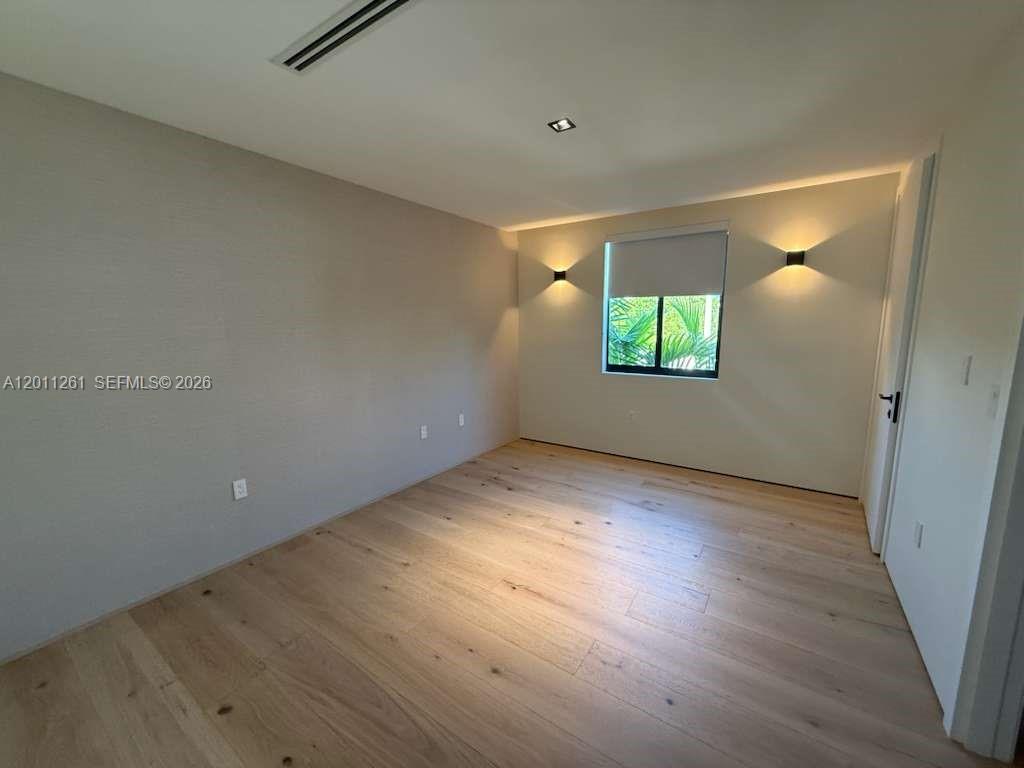 135 Southwest 29th Road Miami, FL 33129 - Photo 41 of 47 an empty room with wooden floor and windows
