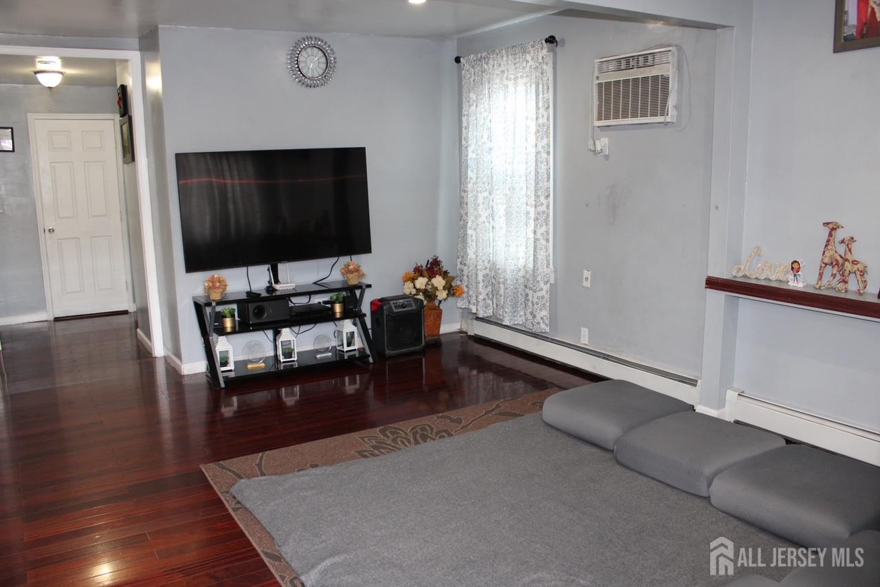 9 Hermann Street Carteret, NJ 07008 - Photo 16 of 23 a living room with furniture and a flat screen tv