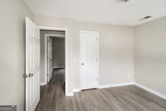 a view of a hallway with wooden floor