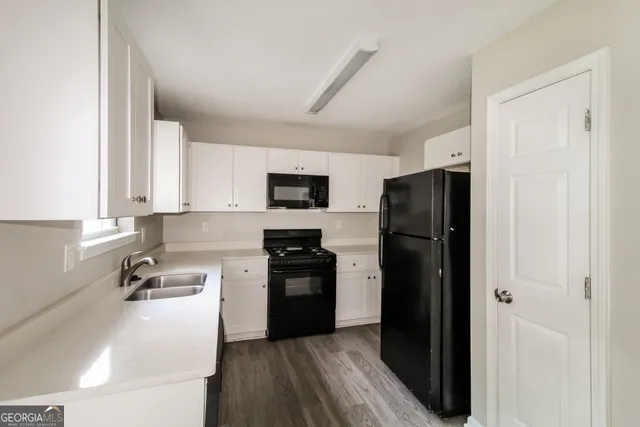 a kitchen with a refrigerator stove and white cabinets