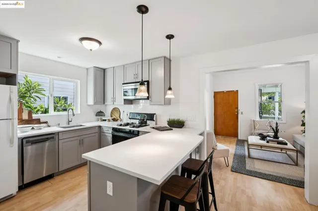 a kitchen with sink a stove and chairs