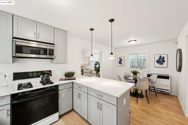 a kitchen with a sink a stove and microwave