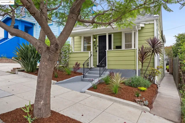 a front view of a house with a garden