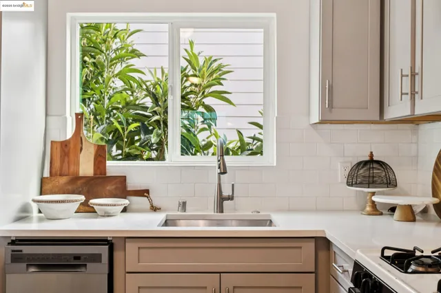 a kitchen with a window a sink and a stove