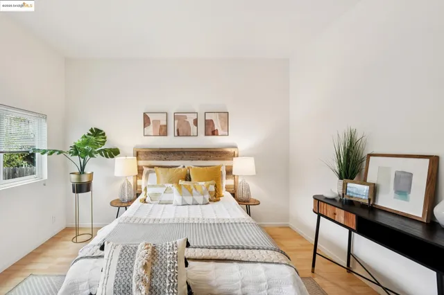 a bedroom with a bed and a potted plant