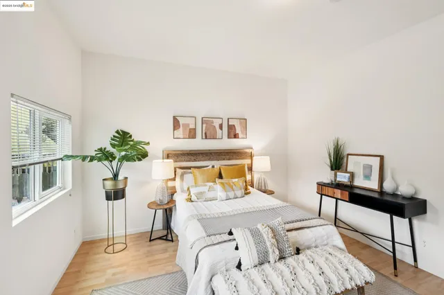 a bedroom with a bed and a potted plant