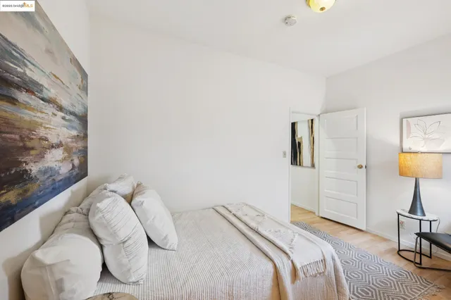 a bedroom with a bed and a lamp