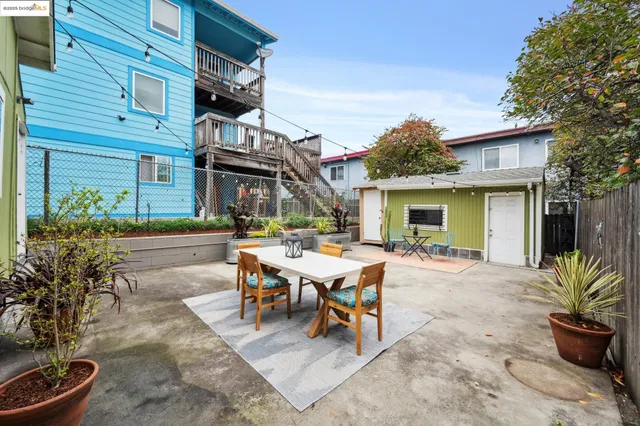 a view of a patio with table and chairs and potted plants