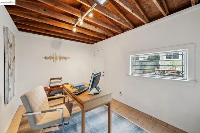 a view of a room with table and chairs