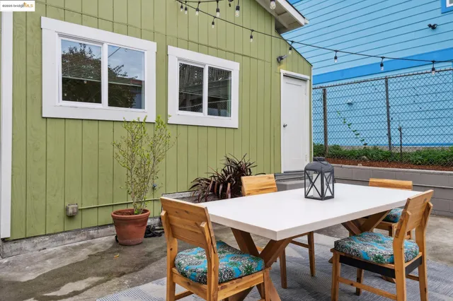 a table and chairs in front of a house