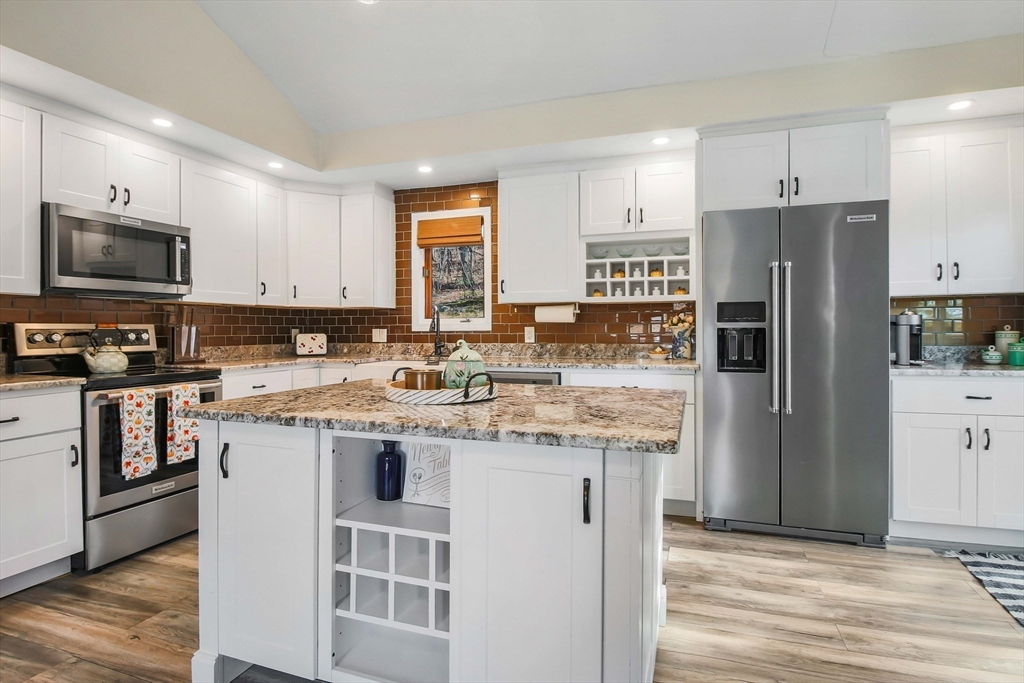 96 Indian Hill Road Worcester, MA 01606 - Photo 14 of 42 a kitchen with stainless steel appliances granite countertop a refrigerator stove microwave and sink