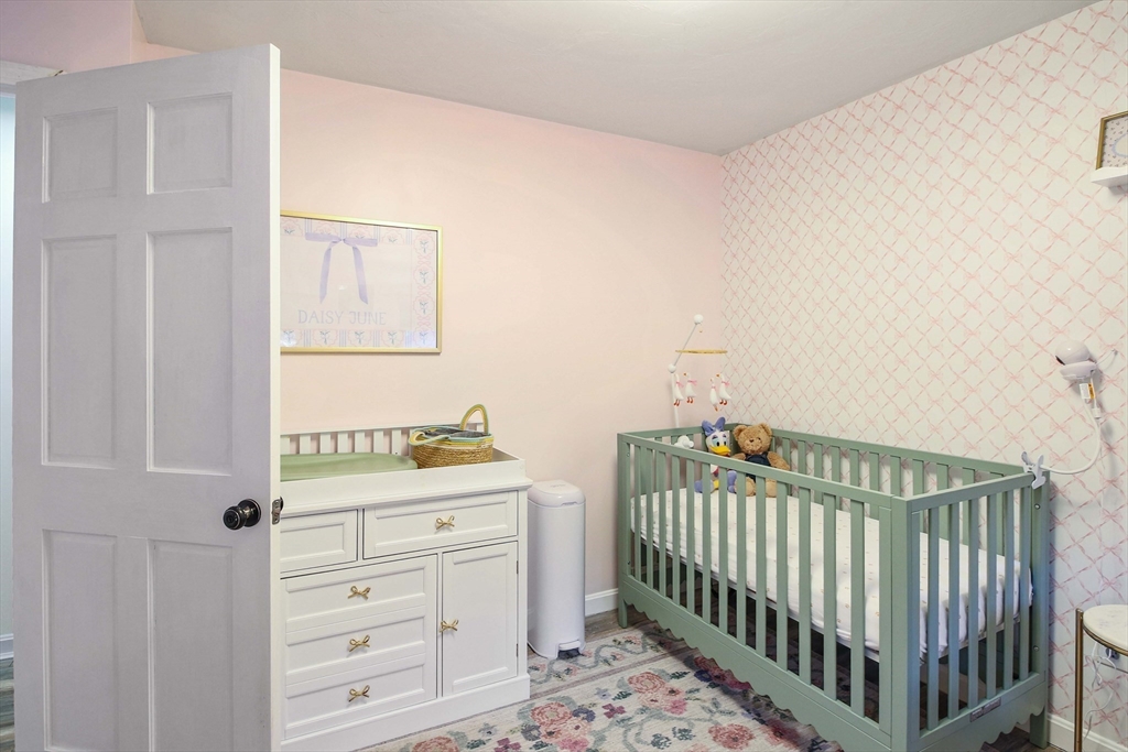 96 Indian Hill Road Worcester, MA 01606 - Photo 19 of 42 a bedroom with a bed and a baby crib