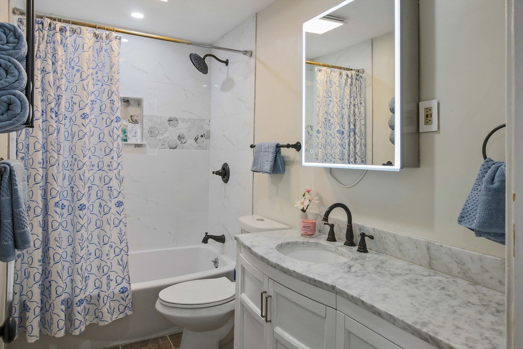 96 Indian Hill Road Worcester, MA 01606 - Photo 22 of 42 a bathroom with a granite countertop sink toilet and shower