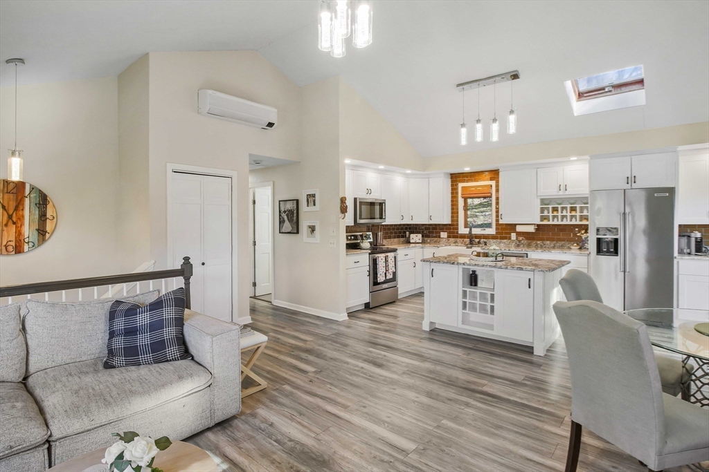 96 Indian Hill Road Worcester, MA 01606 - Photo 3 of 42 a living room with stainless steel appliances kitchen island granite countertop furniture and a kitchen view
