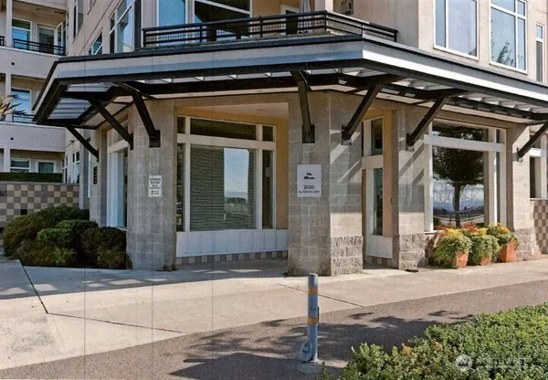 a view of a balcony with chairs and a potted plant