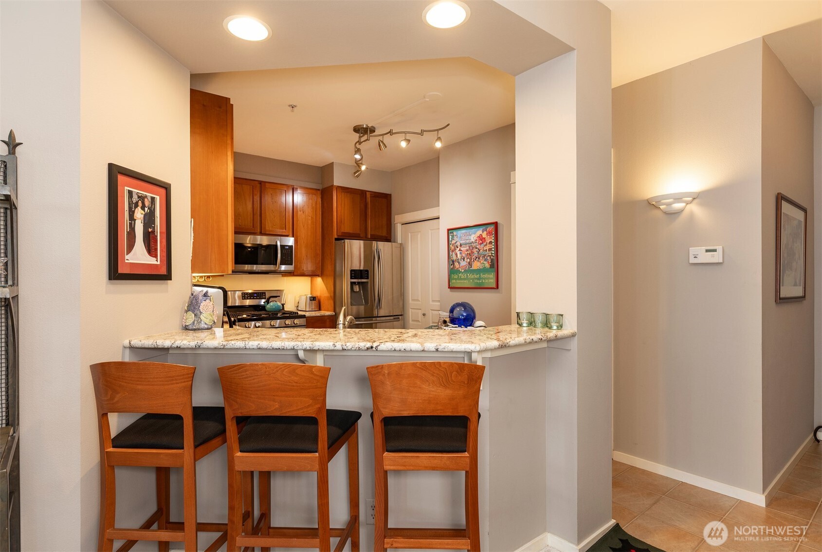 2000 Alaskan Way, Unit 255 Seattle, WA 98121 - Photo 11 of 31 a kitchen with kitchen island granite countertop a sink and refrigerator