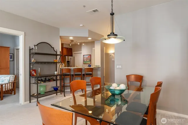 a view of a dining room with furniture and a chandelier