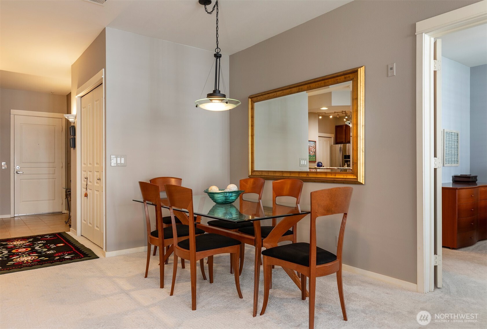 2000 Alaskan Way, Unit 255 Seattle, WA 98121 - Photo 16 of 31 a view of a dining room with furniture and a chandelier