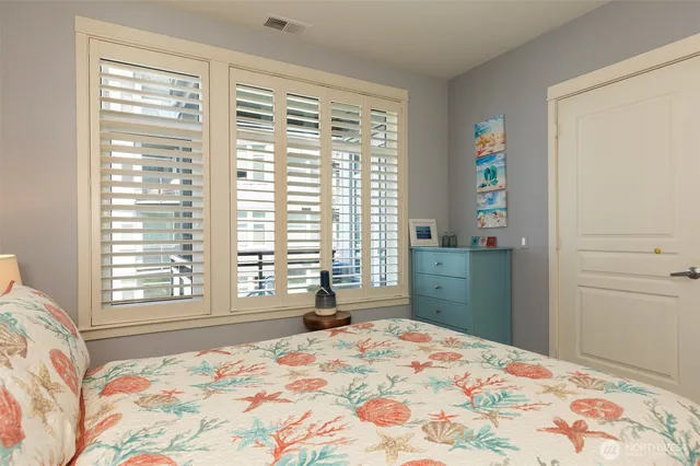 a bedroom with a bed and a lamp