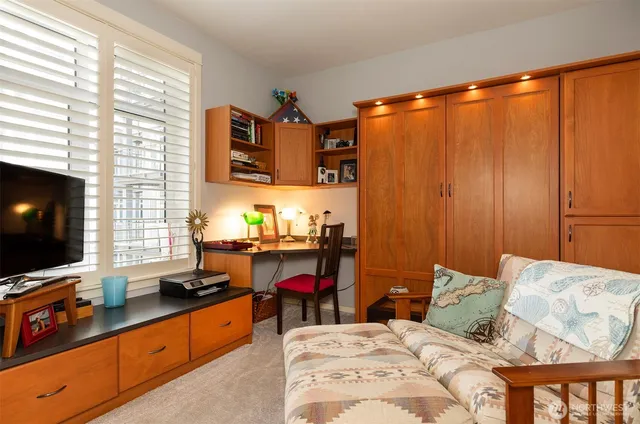 a bedroom with a large bed and a lamp