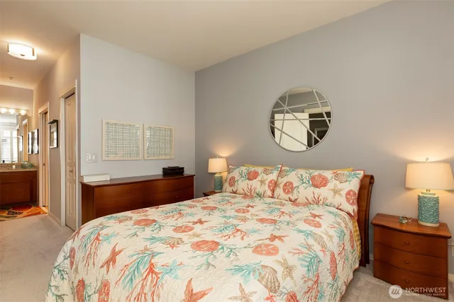 a bathroom with a granite countertop toilet sink and mirror