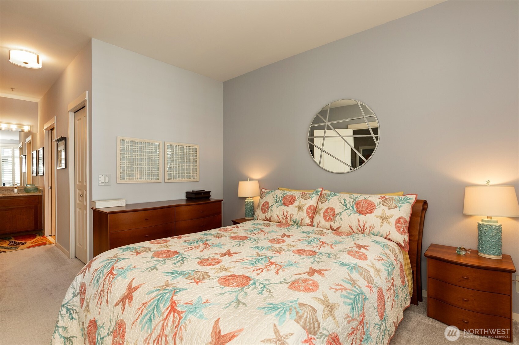 2000 Alaskan Way, Unit 255 Seattle, WA 98121 - Photo 21 of 31 a bedroom with a large bed and a lamp