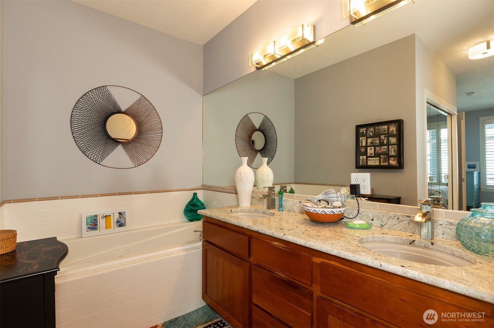 2000 Alaskan Way, Unit 255 Seattle, WA 98121 - Photo 23 of 31 a bathroom with a granite countertop sink mirror and toilet