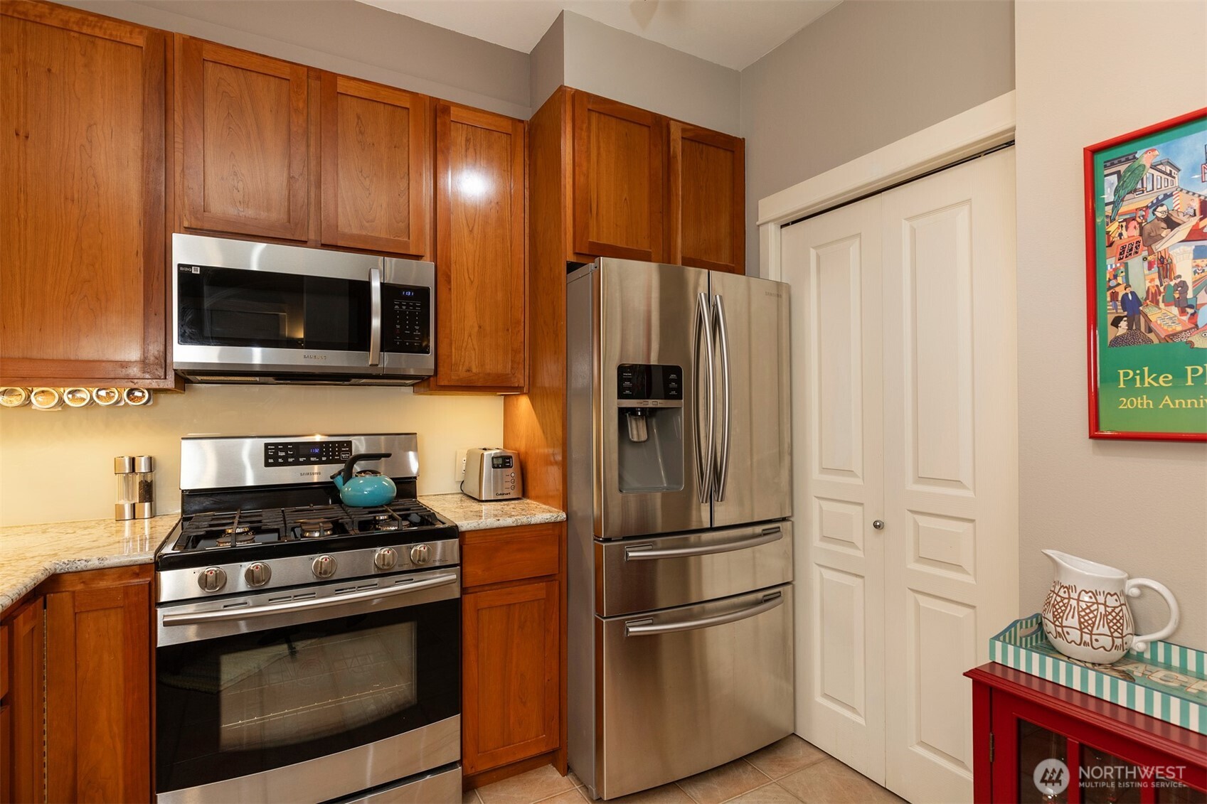 2000 Alaskan Way, Unit 255 Seattle, WA 98121 - Photo 10 of 31 a kitchen with stainless steel appliances a refrigerator stove and microwave