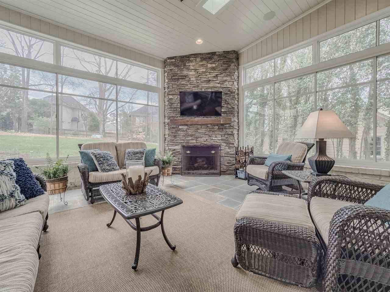 3309 Thomas Road Raleigh, NC 27607 - Photo 4 of 30 This is a special feature of the house. The patio has a bluestone floor, a wood burning fireplace, and enclosed with EZ Breeze slider windows. Keep the pollen out and the heat in! Enclosed Patio