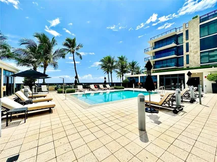 a view of swimming pool with outdoor seating