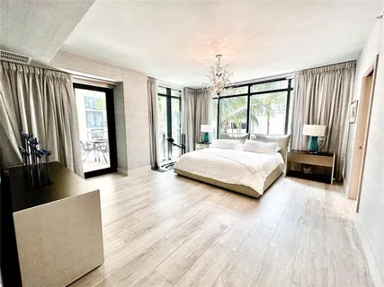 a bedroom with a large bed and a large window