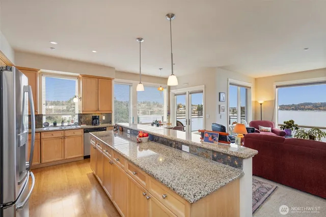 a kitchen with stainless steel appliances granite countertop a stove and a granite counter top